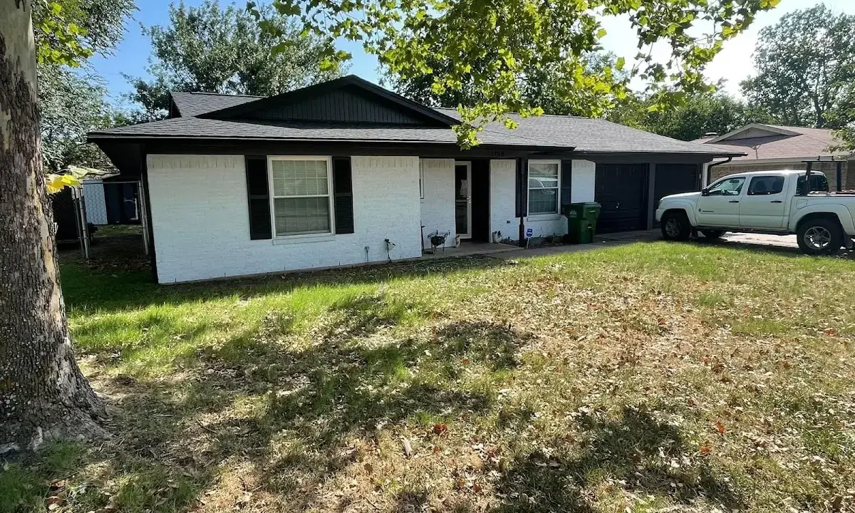 Professional roofing crew working on a residential roof in Lower Makefield